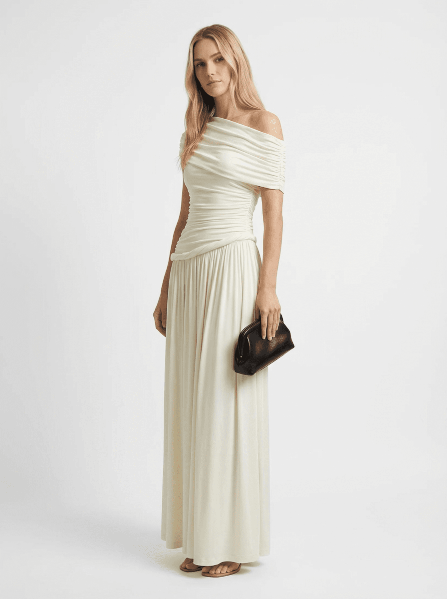 Ivory Off-Shoulder Draped Maxi Dress by COCOSIN